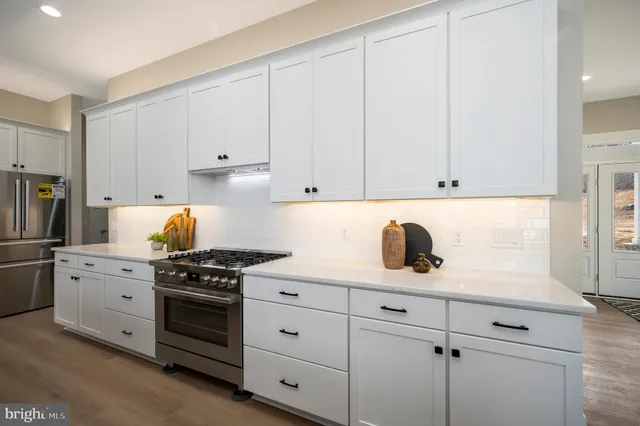 a bathroom with a sink and mirror with bathtub