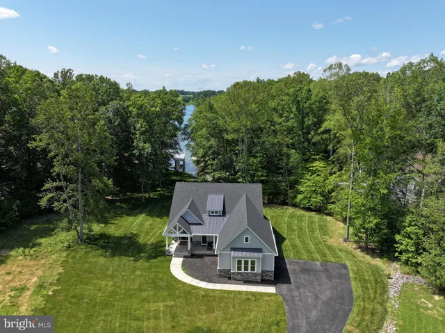 an aerial view of a house with swimming pool and a yard
