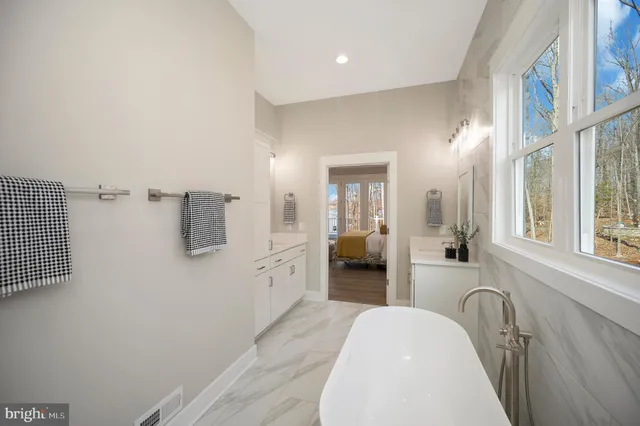 a large kitchen with a table and chairs