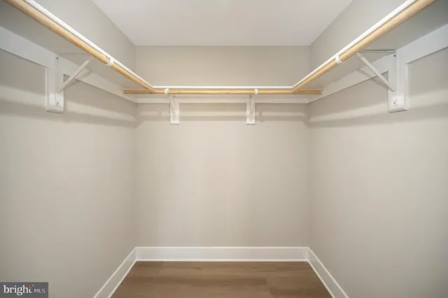 a kitchen with stainless steel appliances kitchen island granite countertop a sink and refrigerator