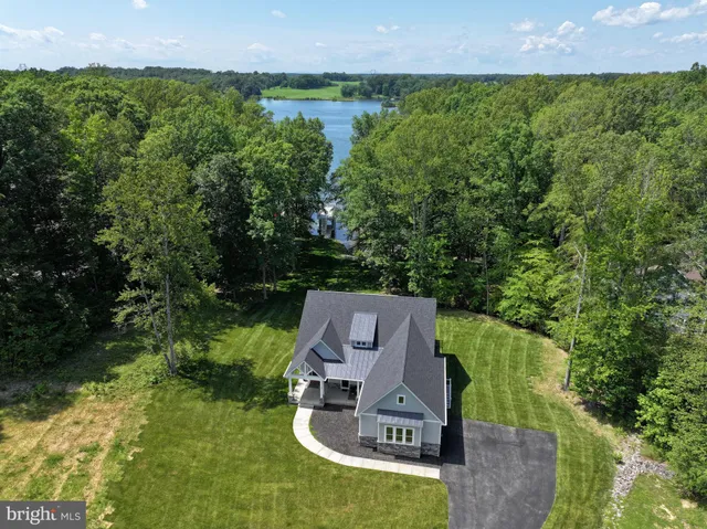 an aerial view of a house with garden space and street view