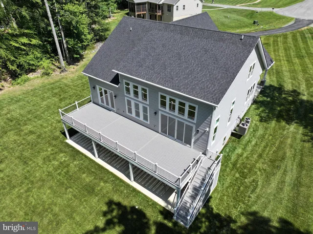 an aerial view of a house with a yard