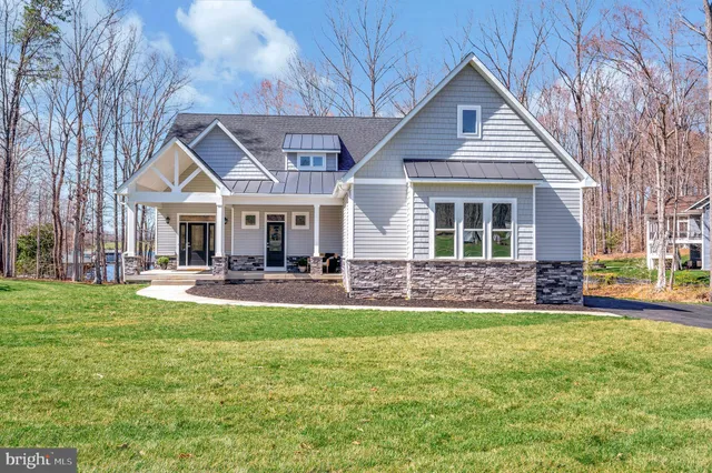 a living room with fireplace furniture and a floor to ceiling window
