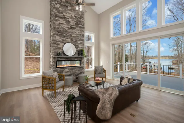a living room with furniture and a floor to ceiling window