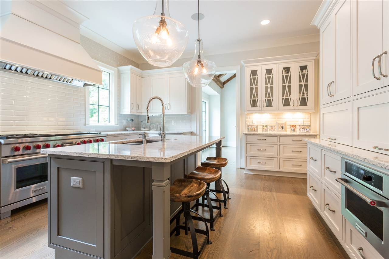 1613 10th Avenue Raleigh, NC 27607 - Photo 10 of 30 a kitchen with kitchen island granite countertop a sink cabinets and stainless steel appliances