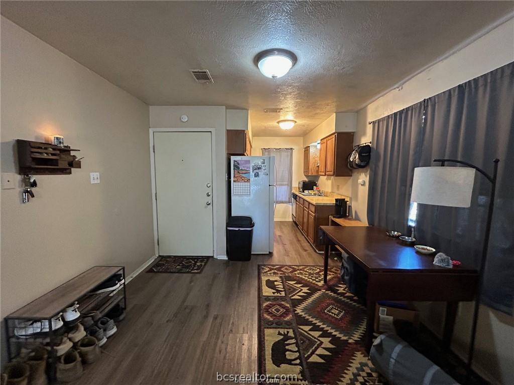 1504 Pine Ridge Drive, Unit A College Station, TX 77840 - Photo 4 of 15 a living room with furniture and a wooden floor