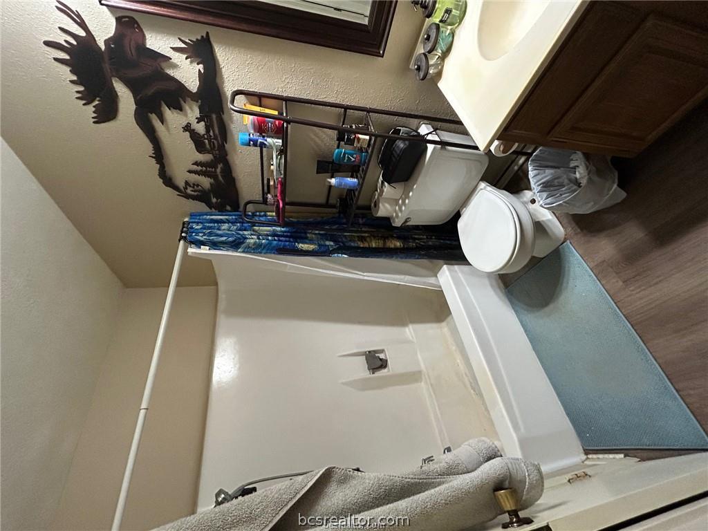 1504 Pine Ridge Drive, Unit A College Station, TX 77840 - Photo 9 of 15 a bathroom with a sink toilet and shower
