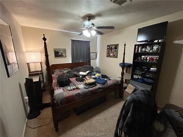 a bed room with furniture and a flat screen tv