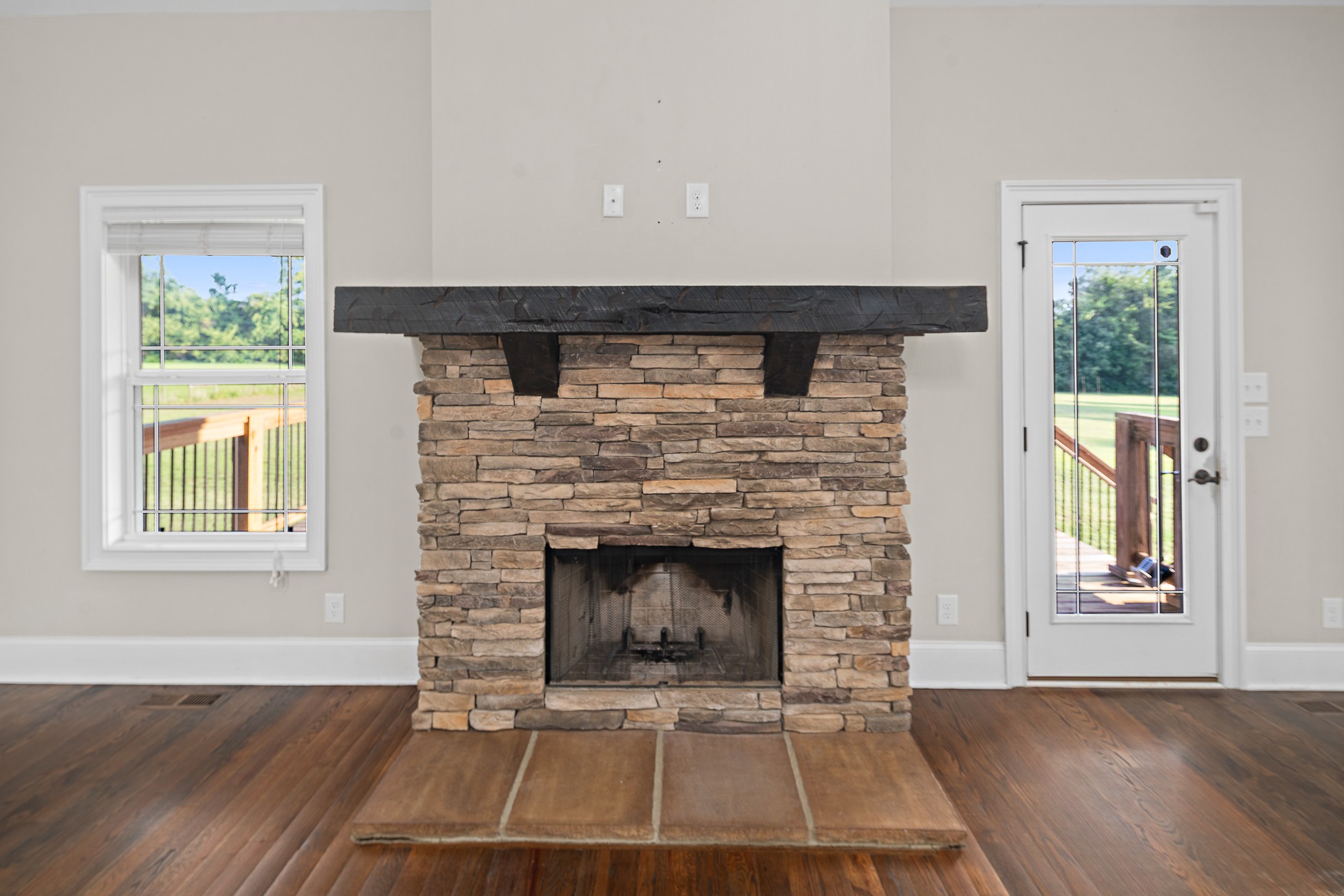 330 Bates Road Lebanon, TN 37087 - Photo 8 of 53 an empty room with wooden floor fireplace and windows