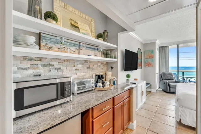 a kitchen with stainless steel appliances kitchen island granite countertop a stove and a sink