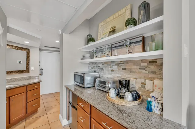 a kitchen with a sink and a stove with cabinets