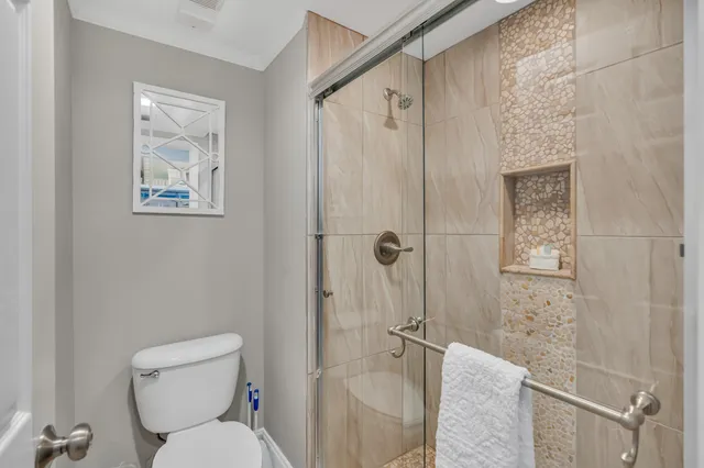 a white toilet sitting next to a bathroom