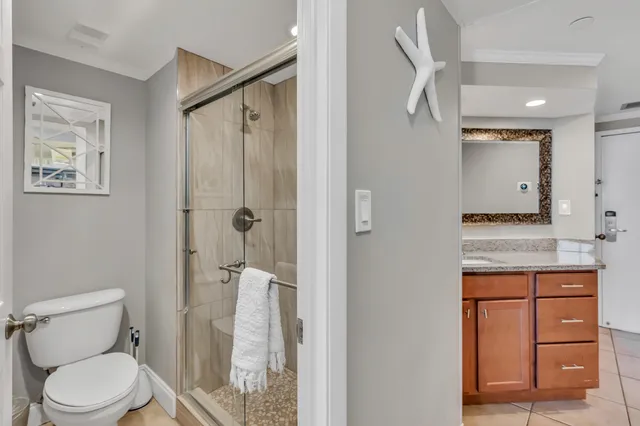 a bathroom with a granite countertop sink toilet and shower
