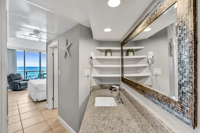 a room with stainless steel appliances furniture and a rug