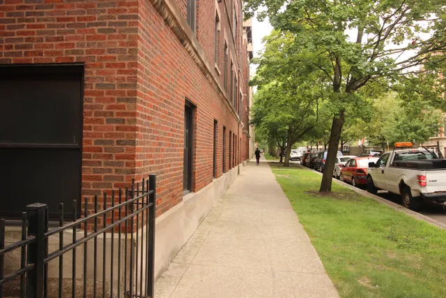 a view of a street with cars parked on the road