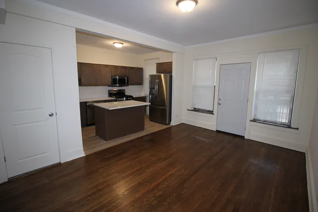 a kitchen with stainless steel appliances granite countertop a refrigerator and a stove
