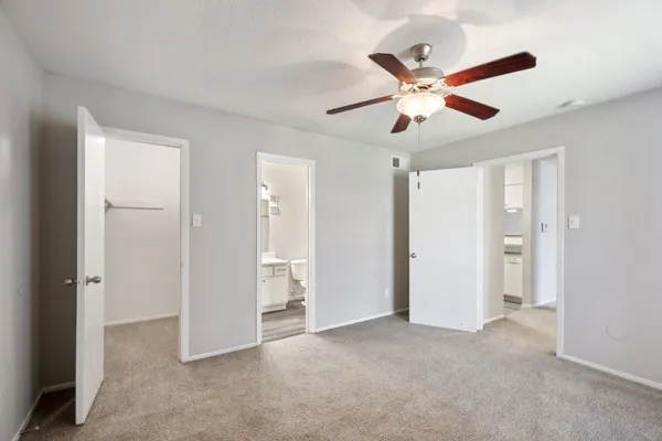 a view of an empty room with a ceiling fan