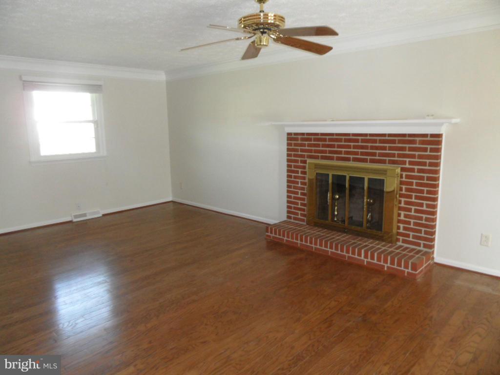 1405 Clearview Road Edgewood, MD 21040 - Photo 7 of 23 an empty room with wooden floor fireplace and windows