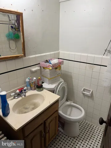 a bathroom with a sink toilet and a mirror