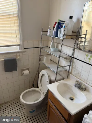 a view of a kitchen with fridge and workspace