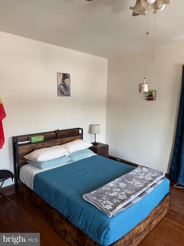 a bedroom with a bed a couch and a window