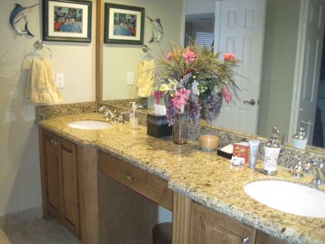 5038 Marina Circle Boca Raton, FL 33486 - Photo 12 of 19 a bathroom with a granite countertop sink a mirror and a shower