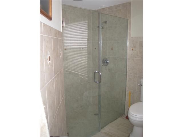 5038 Marina Circle Boca Raton, FL 33486 - Photo 14 of 19 a bathroom with a shower and a toilet