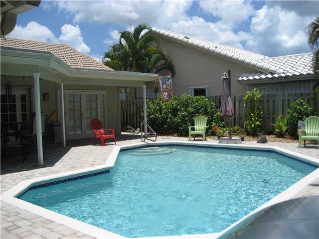 5038 Marina Circle Boca Raton, FL 33486 - Photo 16 of 19 a view of a house with swimming pool patio and a garden