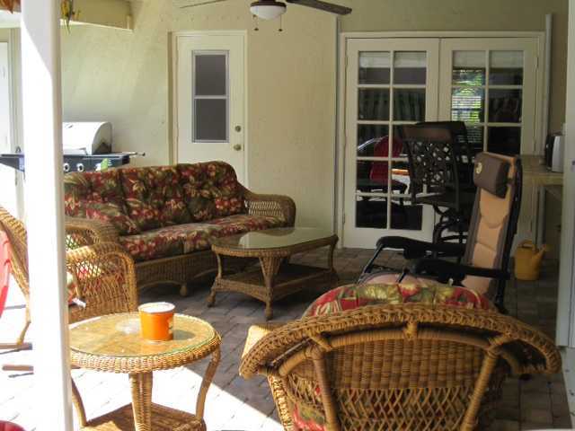 5038 Marina Circle Boca Raton, FL 33486 - Photo 17 of 19 a living room with furniture a window and a table