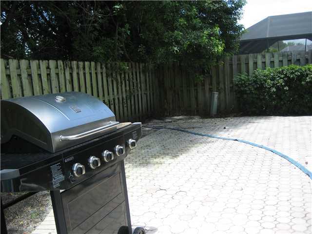 5038 Marina Circle Boca Raton, FL 33486 - Photo 19 of 19 a backyard of a house with garden