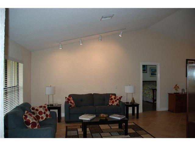 5038 Marina Circle Boca Raton, FL 33486 - Photo 2 of 19 a living room with furniture and a flat screen tv