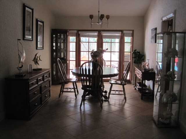 5038 Marina Circle Boca Raton, FL 33486 - Photo 4 of 19 a view of a dining room with furniture window and wooden floor