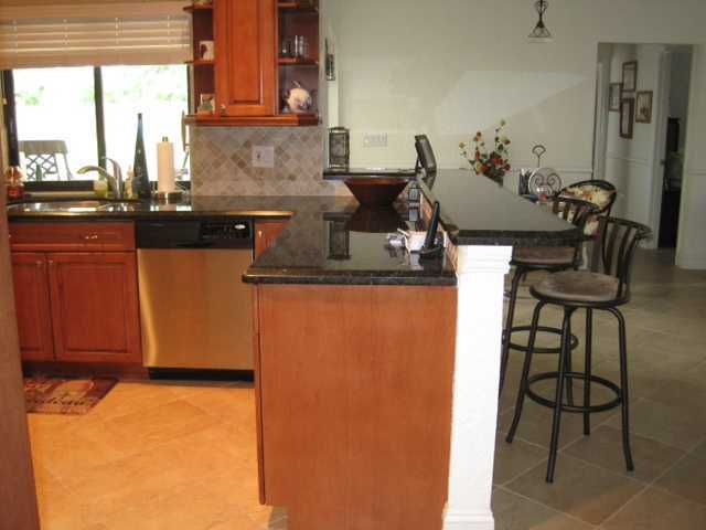 5038 Marina Circle Boca Raton, FL 33486 - Photo 6 of 19 a kitchen with stainless steel appliances granite countertop a sink a stove and a refrigerator