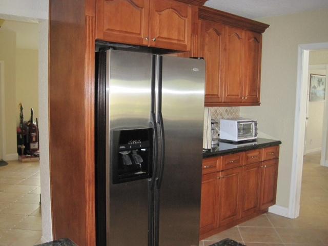5038 Marina Circle Boca Raton, FL 33486 - Photo 7 of 19 a kitchen with stainless steel appliances granite countertop a refrigerator and a sink