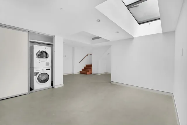 a view of a storage & utility room with two washing machine