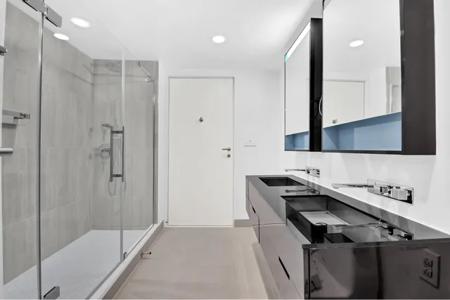 a bathroom with a shower sink and mirror