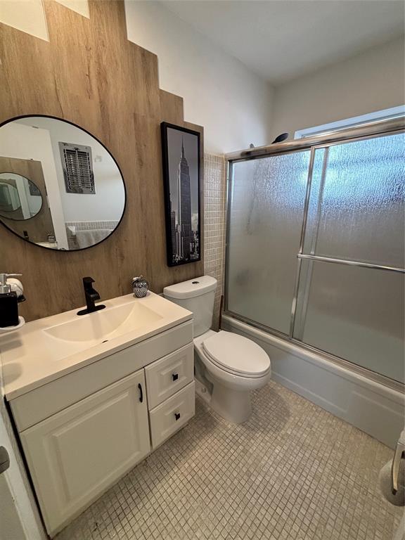 4310 Northwest 12th Court, Unit 308 Lauderhill, FL 33313 - Photo 16 of 24 a bathroom with a toilet a sink and mirror