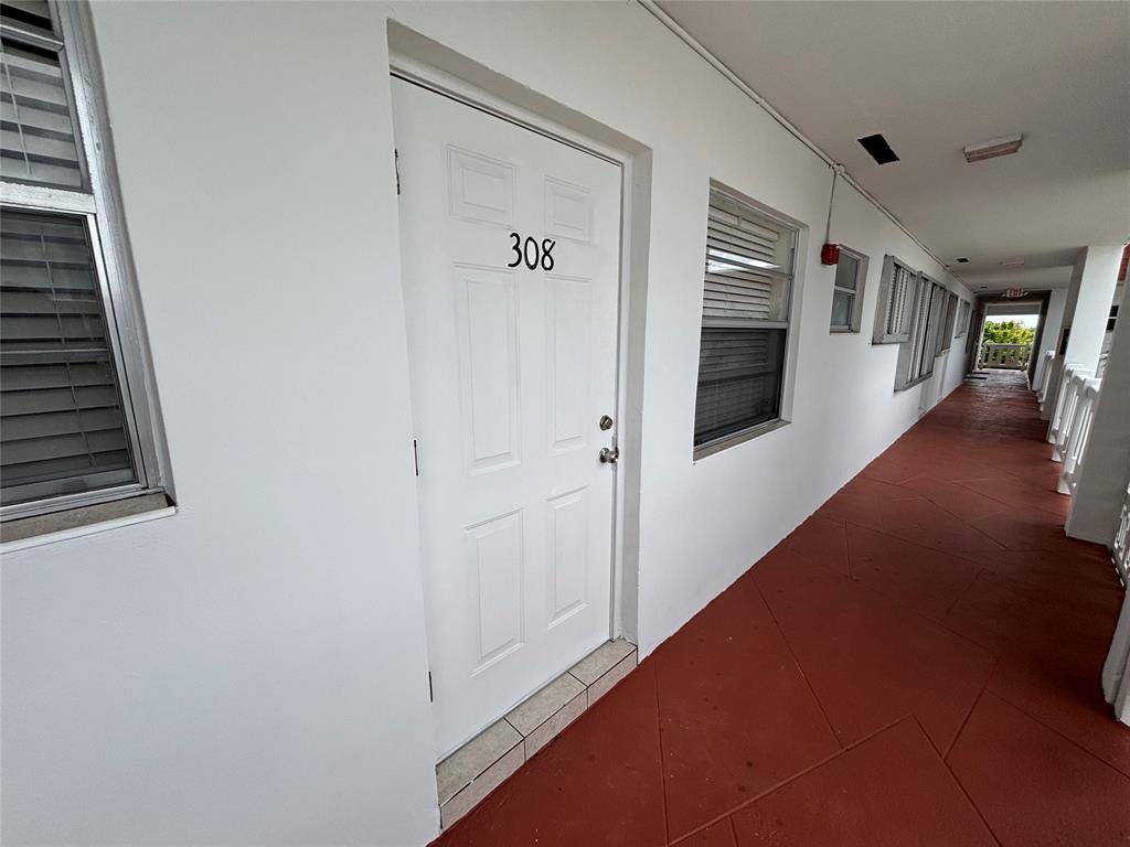 4310 Northwest 12th Court, Unit 308 Lauderhill, FL 33313 - Photo 23 of 24 a view of a hallway with wooden floor and staircase