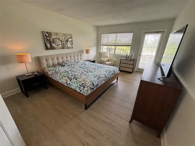 a bedroom with a bed window and a couch