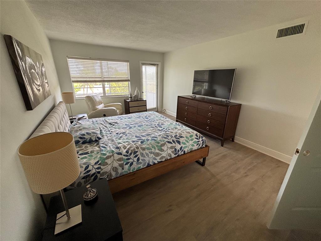 4310 Northwest 12th Court, Unit 308 Lauderhill, FL 33313 - Photo 8 of 24 a bedroom with a bed window and television