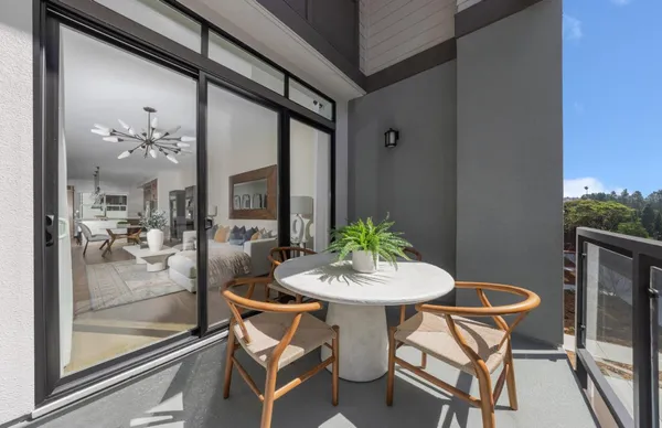 a view of a dining room with furniture and a potted plant