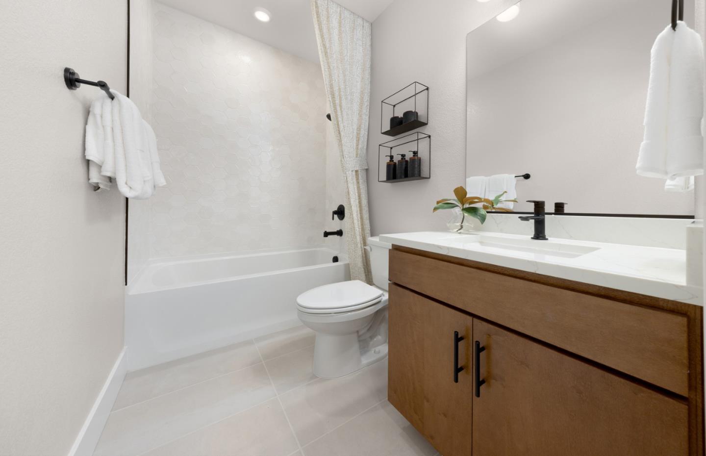 2457 Willow Way San Mateo, CA 94403 - Photo 2 of 13 a bathroom with a granite countertop sink a toilet and shower