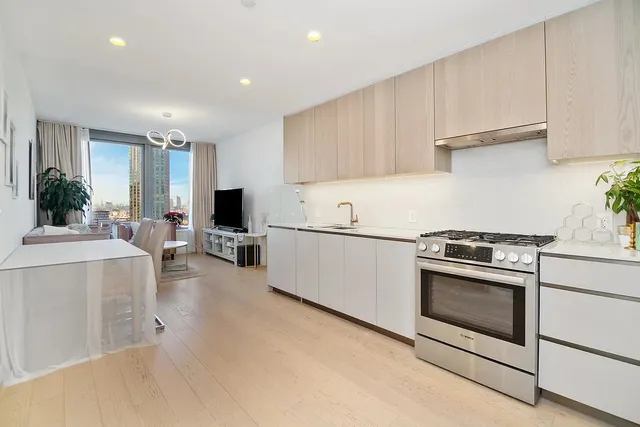 a kitchen with cabinets and stainless steel appliances