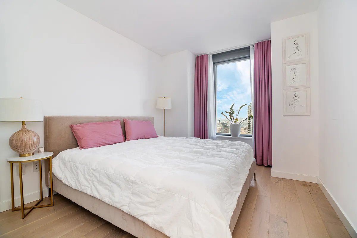 3 Court Square, Unit 1909 Queens, NY 11101 - Photo 3 of 6 a bedroom with a bed and closet