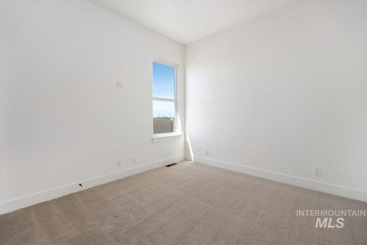 563 Moonstone Road Kimberly, ID 83341 - Photo 30 of 48 Neutral wall paint, carpet flooring, and a single window with white trim