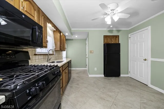 an empty room with closet and a chandelier fan