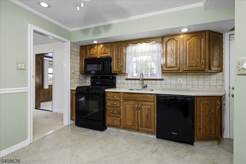 112 Union Street Cedar Grove, NJ 07009 - Photo 22 of 43 a kitchen with granite countertop a stove a sink and a refrigerator