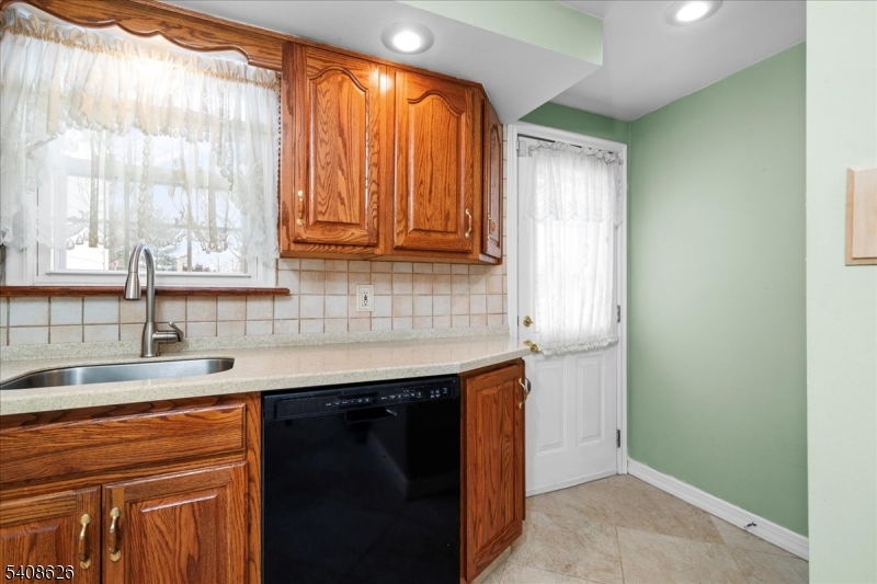 112 Union Street Cedar Grove, NJ 07009 - Photo 23 of 43 a kitchen with stainless steel appliances granite countertop a sink and a window
