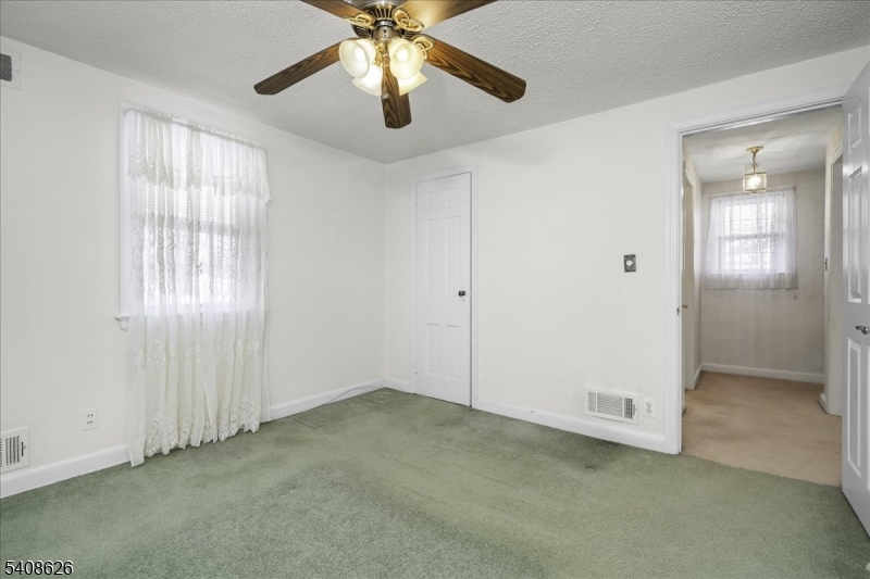112 Union Street Cedar Grove, NJ 07009 - Photo 27 of 43 an empty room with chandelier fan