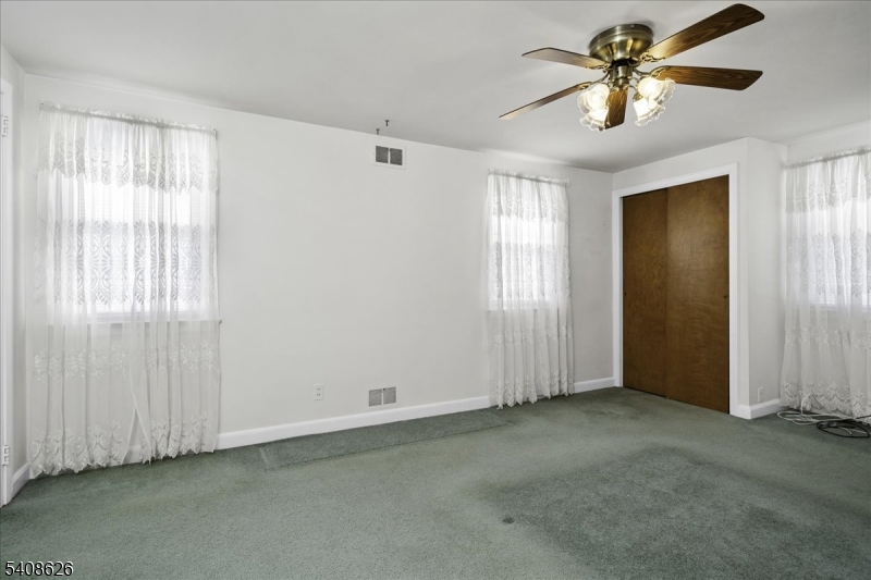 112 Union Street Cedar Grove, NJ 07009 - Photo 30 of 43 a view of a livingroom with a chandelier fan and windows